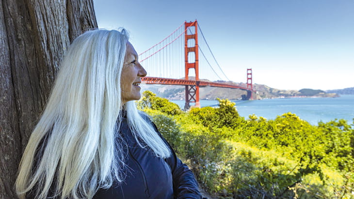 A woman looking at the Golden Gate Bridge in San Francisco, USA
